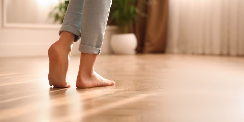 A women with rolled up jeans walking barefoot. The floors have underfloor heating.