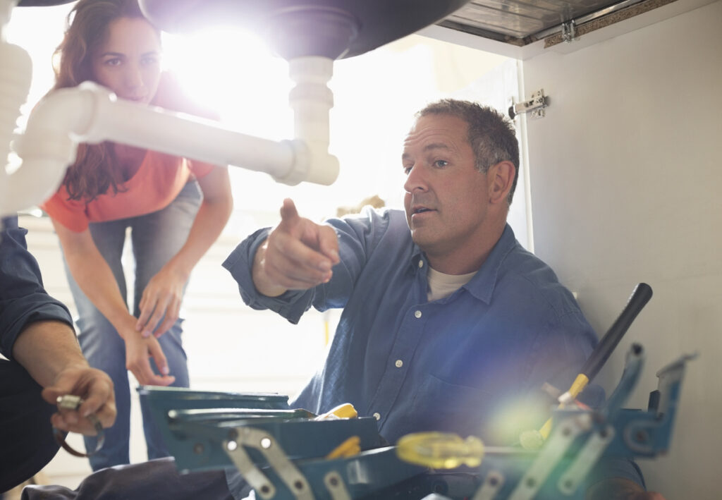 White male telling a woman How to Replace a Kitchen Sink Faucet